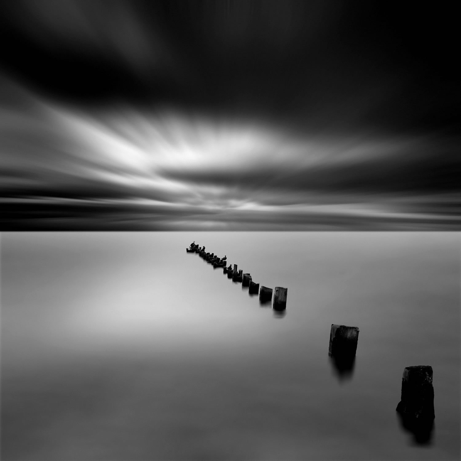 still water cloudy skies black and white